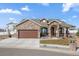 Beautiful home featuring a stone archway entry, stone accents and a large driveway at 156 Chapel Hill Cir, Brighton, CO 80601