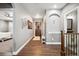 Hallway with wood floors, decorative mirrors, and an entryway door for a welcoming and elegant touch at 156 Chapel Hill Cir, Brighton, CO 80601