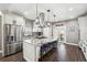 Bright kitchen with an island, a stainless steel fridge, granite countertops and modern appliances at 156 Chapel Hill Cir, Brighton, CO 80601