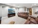 Comfortable living room area in a finished basement with a large screen TV and plush seating at 156 Chapel Hill Cir, Brighton, CO 80601