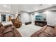 Bright basement living area with neutral carpet, recessed lighting, and modern entertainment center at 156 Chapel Hill Cir, Brighton, CO 80601