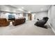 Spacious finished basement living room features neutral carpeting, recessed lighting, and comfortable leather seating at 156 Chapel Hill Cir, Brighton, CO 80601