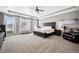 Serene main bedroom with large windows, carpet, and a neutral color palette at 156 Chapel Hill Cir, Brighton, CO 80601