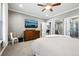 Spacious main bedroom with a large dresser, TV, ceiling fan and access to the on-suite bathroom at 156 Chapel Hill Cir, Brighton, CO 80601
