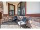 Cozy porch featuring decorative stone and two chairs with a small table at 156 Chapel Hill Cir, Brighton, CO 80601
