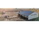 Large white metal barn with paddock and fenced area at 35055 E Mississippi Ave, Watkins, CO 80137