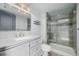 Stylish bathroom featuring a sleek vanity, glass-enclosed shower with modern fixtures, and ample space at 35055 E Mississippi Ave, Watkins, CO 80137