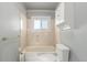 Clean bathroom features a bathtub with shower, a toilet, and a storage cabinet at 35055 E Mississippi Ave, Watkins, CO 80137