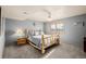 Relaxing bedroom with a rustic-style wooden bed frame, ceiling fan, and window with blinds at 35055 E Mississippi Ave, Watkins, CO 80137