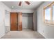 Comfortable bedroom with neutral carpet, closet, and a large window offering ample natural light at 35055 E Mississippi Ave, Watkins, CO 80137