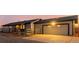 Exterior shot of attached garage and the home's side, accented by wood fence and evening light at 35055 E Mississippi Ave, Watkins, CO 80137