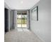 Bright hallway with a sliding glass door leading to the backyard, with neutral paint and carpeting at 35055 E Mississippi Ave, Watkins, CO 80137