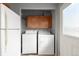 Convenient laundry area with a side-by-side washer and dryer and overhead cabinets for storage at 35055 E Mississippi Ave, Watkins, CO 80137