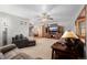Inviting living room with plush furniture, a ceiling fan, and a wooden entertainment center at 35055 E Mississippi Ave, Watkins, CO 80137