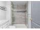 Modern shower with gray tile, glass door, and contemporary fixtures, adding a touch of luxury at 35055 E Mississippi Ave, Watkins, CO 80137