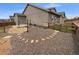 Spacious backyard with a graveled area, stone patio and small, fenced in lawn with new home construction at 950 Avena Ct, Elizabeth, CO 80107