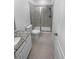 Modern bathroom with tiled floors, walk-in shower with glass door, toilet, and granite vanity at 950 Avena Ct, Elizabeth, CO 80107