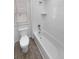 Bright white tiled bathtub and shower combination featuring sleek fixtures and a window at 950 Avena Ct, Elizabeth, CO 80107