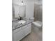 Well lit bathroom with granite countertop vanity, framed mirror, toilet and glass enclosed shower at 950 Avena Ct, Elizabeth, CO 80107