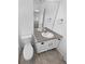 Bright bathroom featuring a modern vanity with a sleek countertop, white cabinets, and a neutral flooring at 950 Avena Ct, Elizabeth, CO 80107
