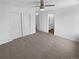 Neutral bedroom featuring a ceiling fan, closet, light walls, and view to bathroom at 950 Avena Ct, Elizabeth, CO 80107