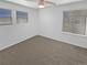 Neutral bedroom with a ceiling fan, light walls, neutral carpet, and two windows at 950 Avena Ct, Elizabeth, CO 80107