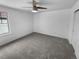 Neutral bedroom with a ceiling fan, light walls, neutral carpet, and a window at 950 Avena Ct, Elizabeth, CO 80107
