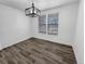 Bright dining room with wood floor, modern chandelier, and a double window with horizontal blinds at 950 Avena Ct, Elizabeth, CO 80107