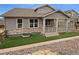 Charming home featuring a covered front porch, stone accents, and well-manicured landscaping at 950 Avena Ct, Elizabeth, CO 80107