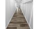 Hallway with wood-look floors leading to other parts of the home at 950 Avena Ct, Elizabeth, CO 80107