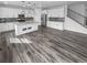 Open kitchen with white cabinets, an island with granite countertops, and hard surface floors at 950 Avena Ct, Elizabeth, CO 80107