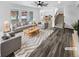 Bright living room with hardwood floors, comfortable seating, and a view into the kitchen and dining area at 950 Avena Ct, Elizabeth, CO 80107
