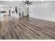 Bright living room featuring hard surface floors, a ceiling fan, and an open concept layout at 950 Avena Ct, Elizabeth, CO 80107
