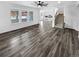 Open-concept living room with hardwood flooring and staircase leading to the upper level at 950 Avena Ct, Elizabeth, CO 80107