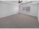 Spacious main bedroom with plush carpeting and ample natural light from two windows at 950 Avena Ct, Elizabeth, CO 80107