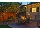 Cozy patio space with chairs, a grill, and ambient lighting perfect for outdoor entertaining at 1250 S Josephine St, Denver, CO 80210