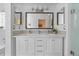 Bathroom featuring a double vanity, modern lighting, large mirror, and tile backsplash at 1250 S Josephine St, Denver, CO 80210