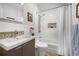 Bathroom with modern vanity, tiled shower and bathtub featuring stylish fixtures and a neutral color palette at 1250 S Josephine St, Denver, CO 80210