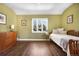 Bright bedroom with hardwood floors, large window, and green walls creating a cozy and inviting space at 1250 S Josephine St, Denver, CO 80210