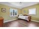 Bright bedroom with hardwood floors, large window, and green walls creating a cozy and inviting space at 1250 S Josephine St, Denver, CO 80210