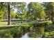 Picturesque scene featuring a small creek running through a lush park with picnic tables at 1250 S Josephine St, Denver, CO 80210