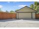 Detached two car garage with a large driveway for parking and a wooden privacy fence at 1250 S Josephine St, Denver, CO 80210