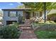 Charming exterior of a home with brick accents, landscaping, and an inviting front porch at 1250 S Josephine St, Denver, CO 80210