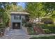Inviting home with brick accents, a well-manicured lawn, and a private driveway to the garage at 1250 S Josephine St, Denver, CO 80210