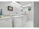 Clean laundry room featuring washer, dryer, utility sink, and ample storage space for convenience at 1250 S Josephine St, Denver, CO 80210