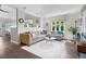 Bright living room featuring hardwood floors, large windows, and stylish decor at 1250 S Josephine St, Denver, CO 80210