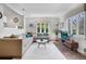 Spacious living room featuring hardwood floors, large windows, and stylish decor at 1250 S Josephine St, Denver, CO 80210
