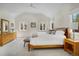 Spacious main bedroom featuring a neutral color scheme, vaulted ceilings, and multiple windows at 1250 S Josephine St, Denver, CO 80210