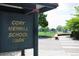The Cory Merrill School Park sign provides community information in an outdoor setting at 1250 S Josephine St, Denver, CO 80210
