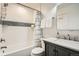 Clean bathroom featuring a shower-tub combination, modern tiles, and vanity with elegant fixtures at 5150 Buckingham Rd, Boulder, CO 80301